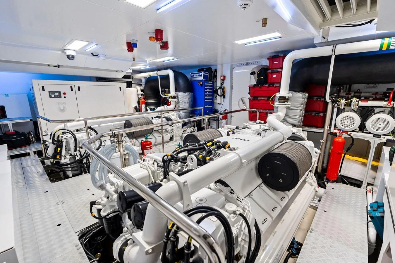 The image showcases a pristine and well-organized engine room with advanced machinery and equipment. aboard TENACIOUS Yacht for Sale
