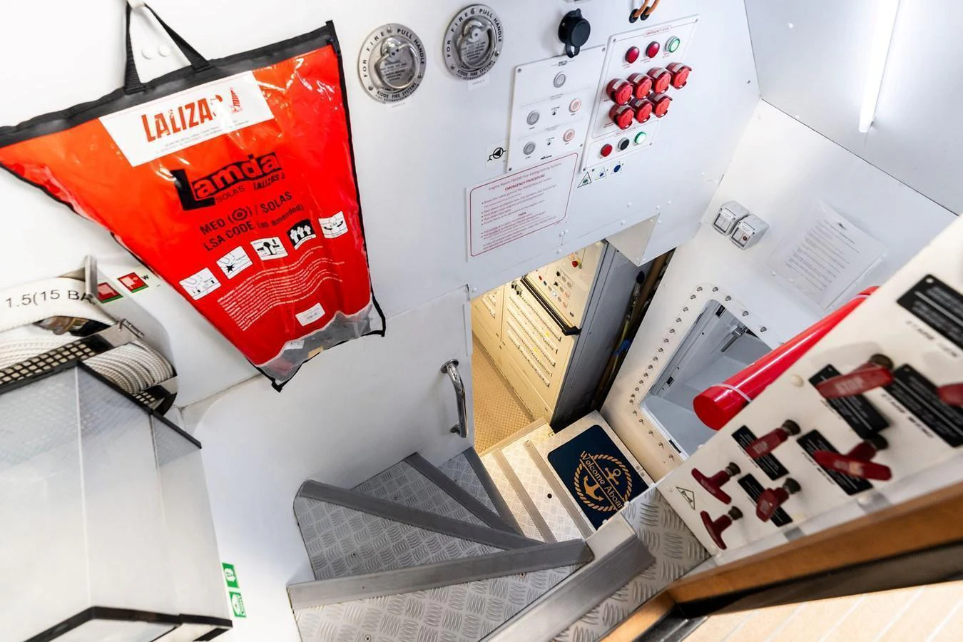 The image showcases a well-organized interior area with safety equipment and control panels. aboard TENACIOUS Yacht for Sale