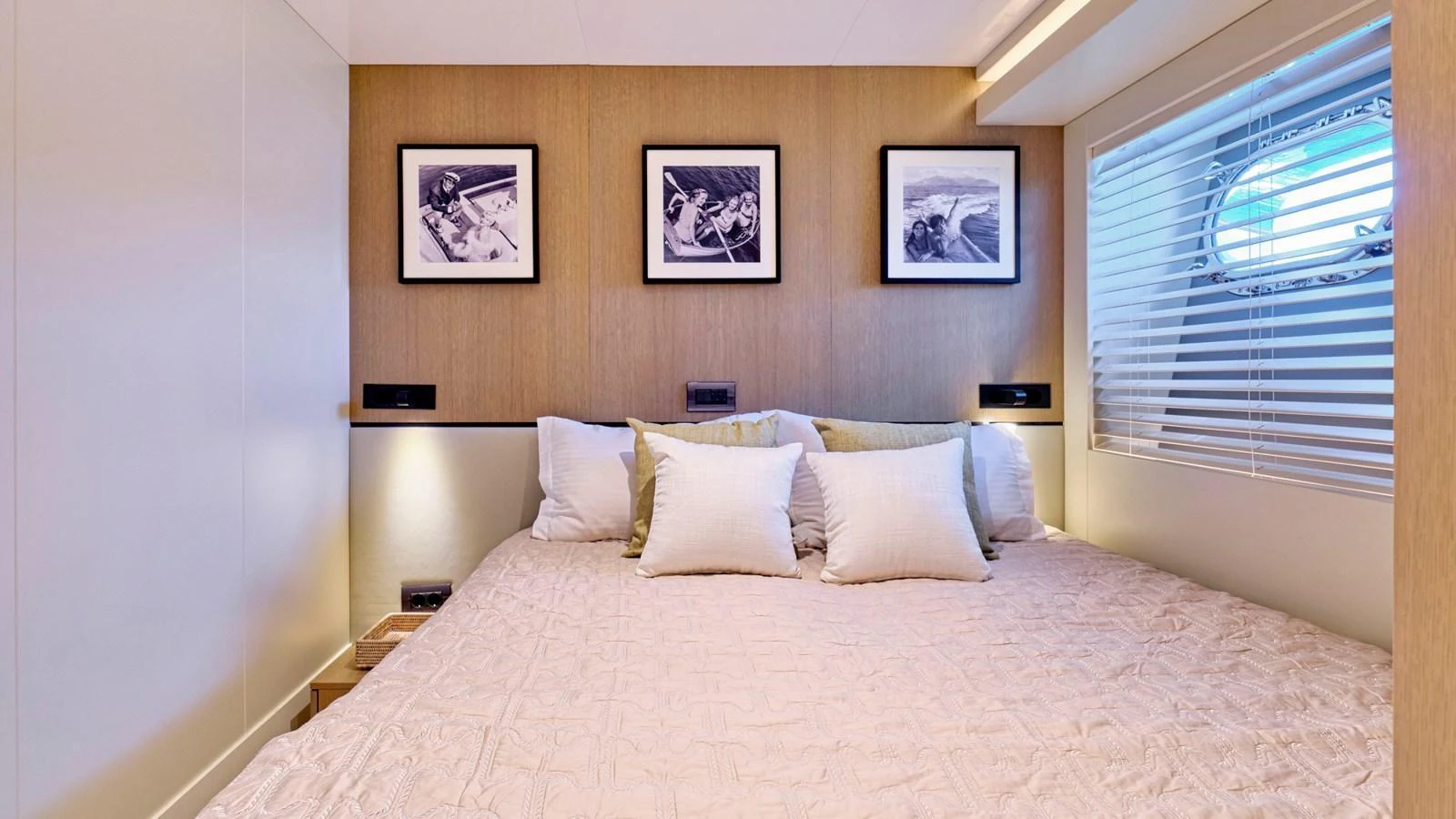 A cozy stateroom with a large bed, soft lighting, and framed artwork on the wall. aboard MILGAUSS Yacht for Sale