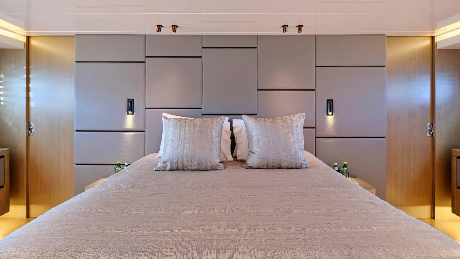 The master stateroom features a luxurious bed with elegant bedding and modern design elements. aboard MILGAUSS Yacht for Sale