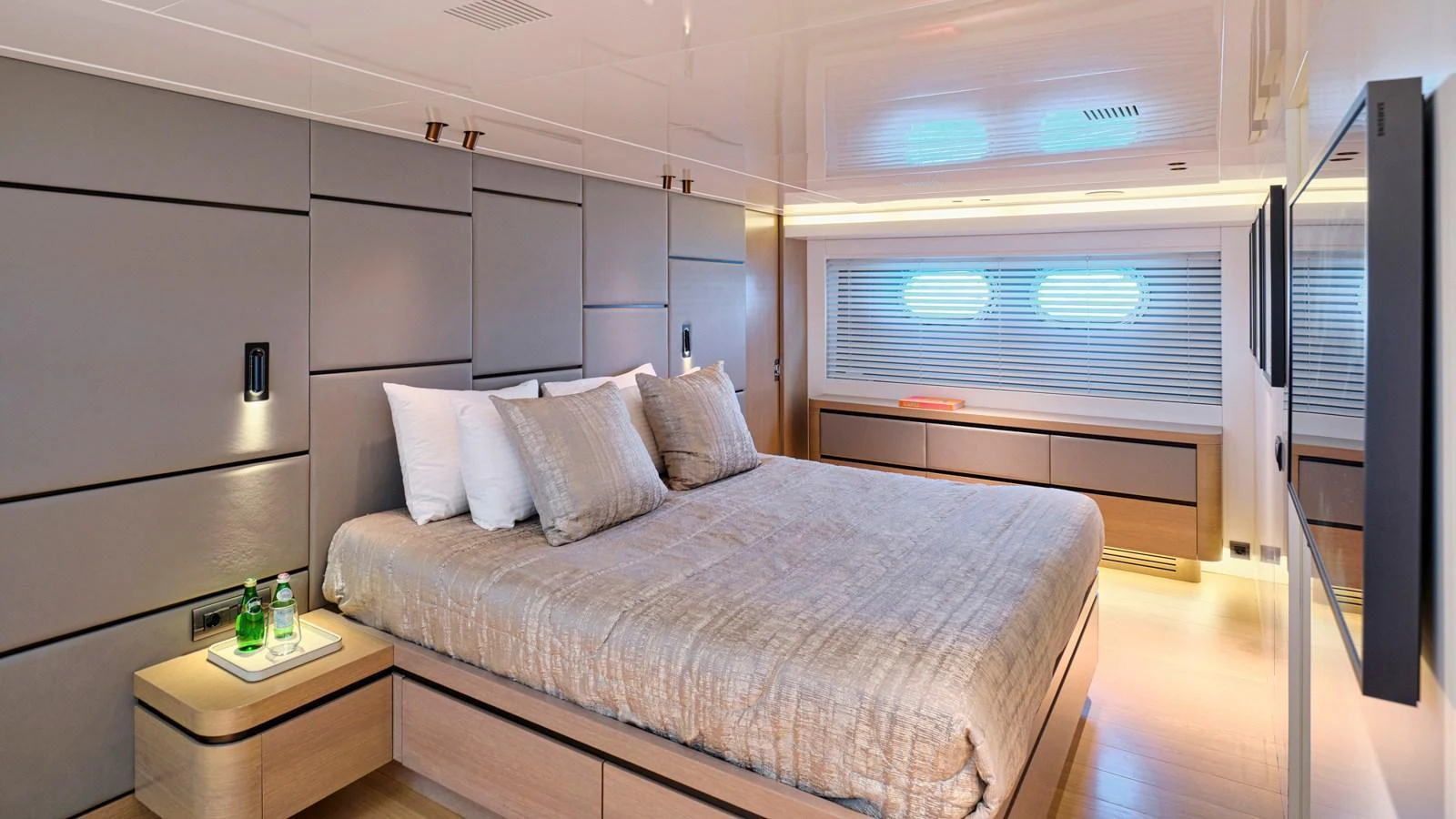 The master stateroom features a spacious bed with modern decor and ample natural light. aboard MILGAUSS Yacht for Sale