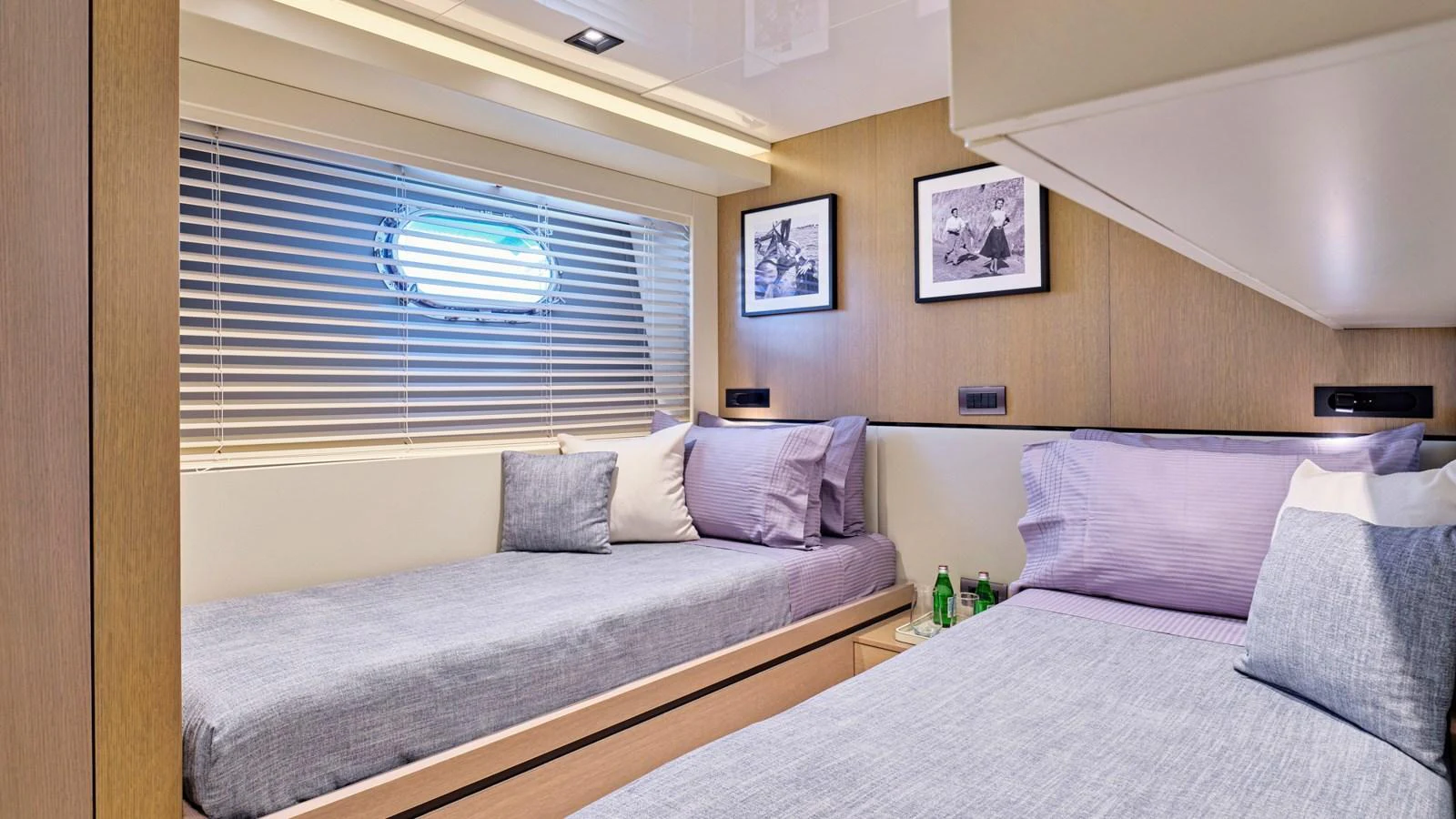 The guest stateroom features twin beds with modern decor and ample natural light from the porthole. aboard MILGAUSS Yacht for Sale