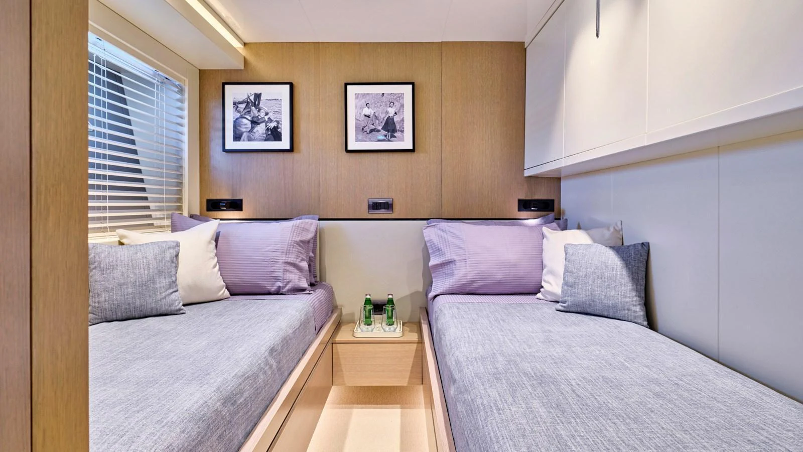 The twin stateroom offers a cozy and inviting space with two single beds and modern decor. aboard MILGAUSS Yacht for Sale