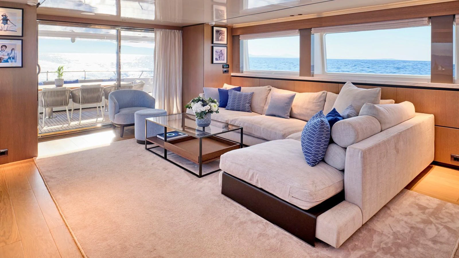 The salon features a spacious and elegantly furnished seating area with large windows offering stunning ocean views. aboard MILGAUSS Yacht for Sale