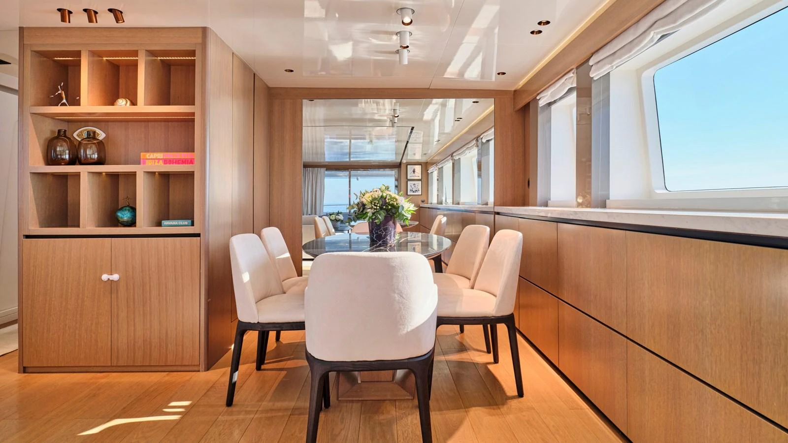 The yacht's dining area features a stylish and modern design with ample natural light. aboard MILGAUSS Yacht for Sale