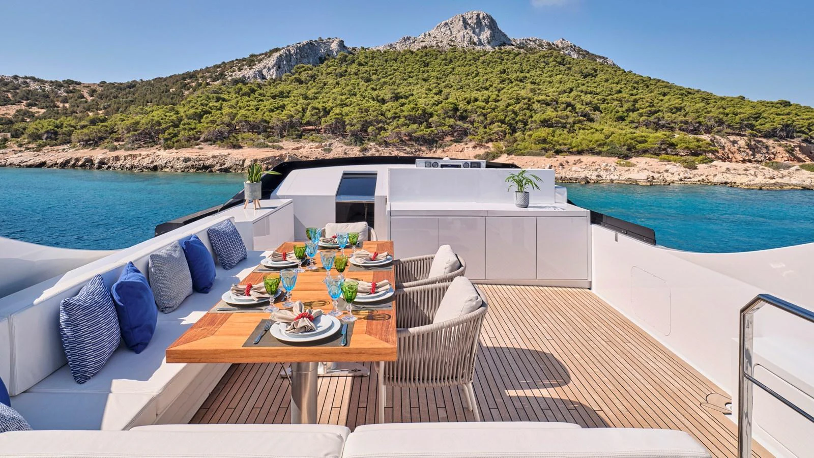The aft deck features an elegant dining area with a stunning view of the surrounding landscape. aboard MILGAUSS Yacht for Sale