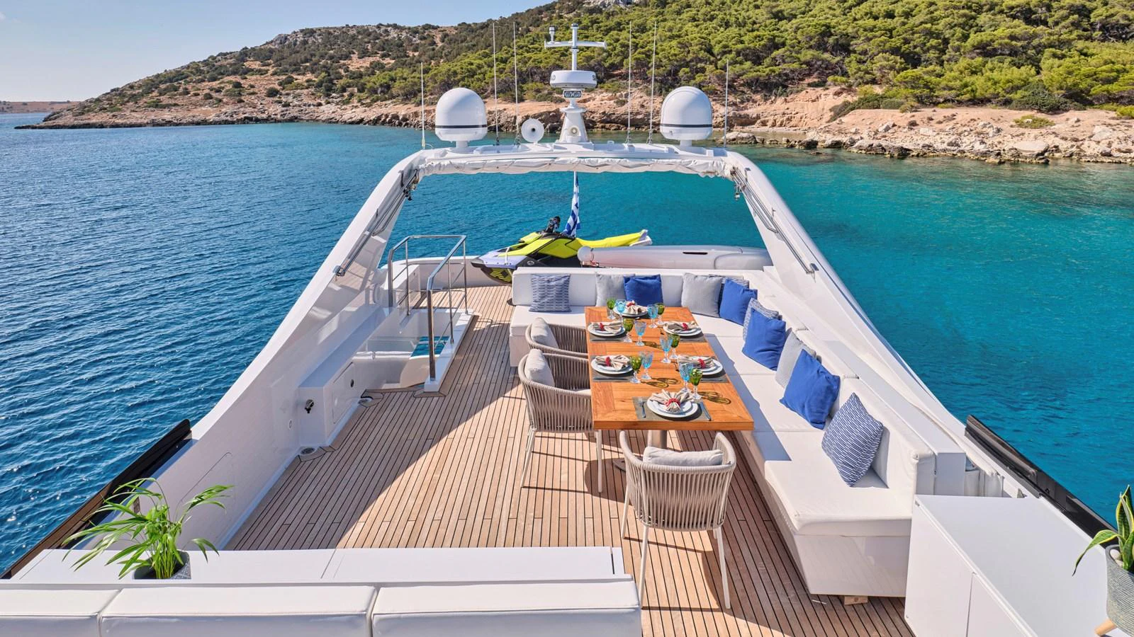 The aft deck features an elegant dining area with a stunning view of the surrounding waters. aboard MILGAUSS Yacht for Sale