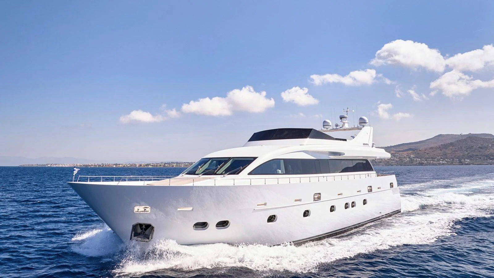 A sleek yacht cruises through the water under a clear blue sky. aboard MILGAUSS Yacht for Sale