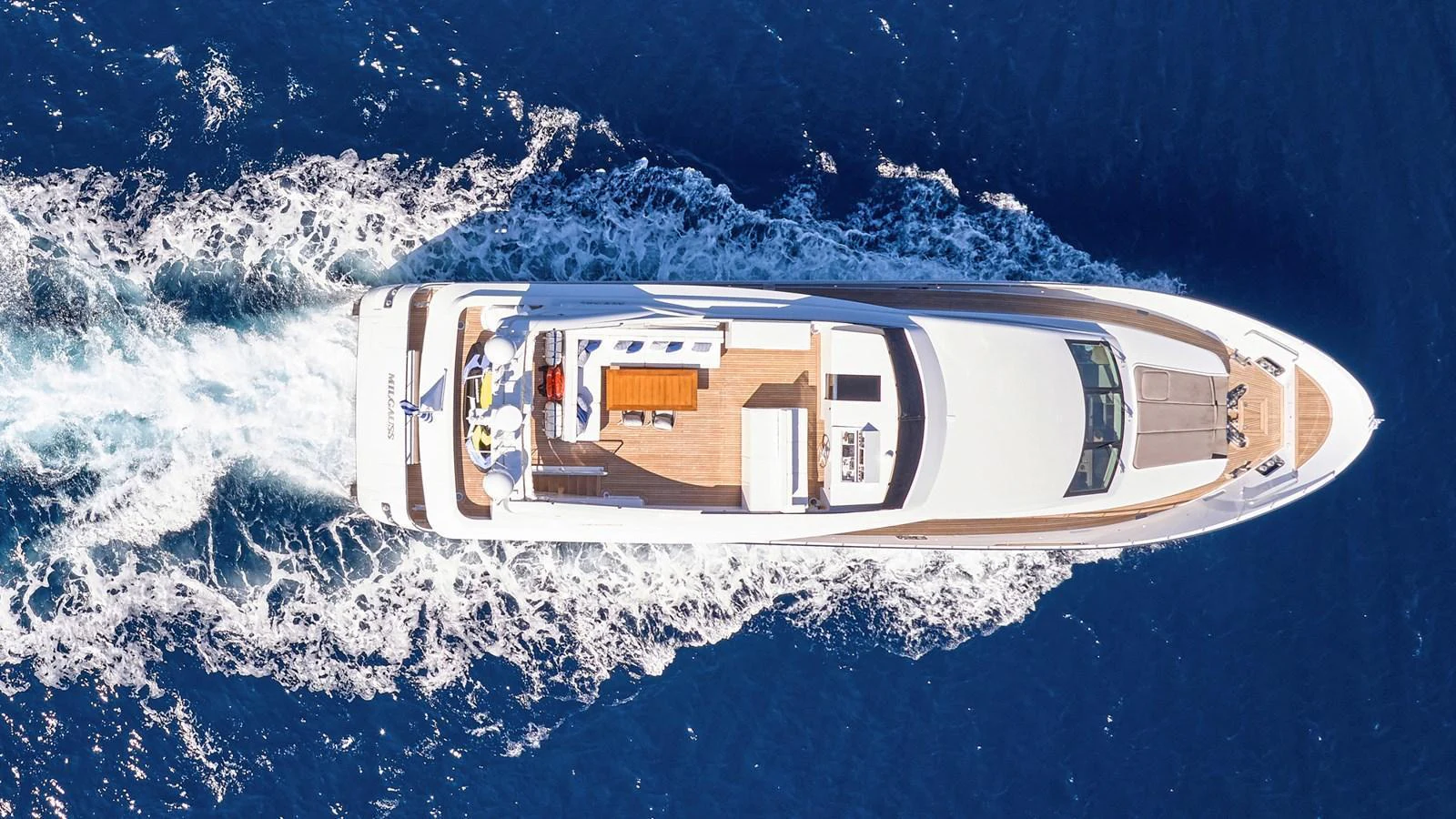An aerial view of a luxurious yacht cruising through the deep blue sea. aboard MILGAUSS Yacht for Sale