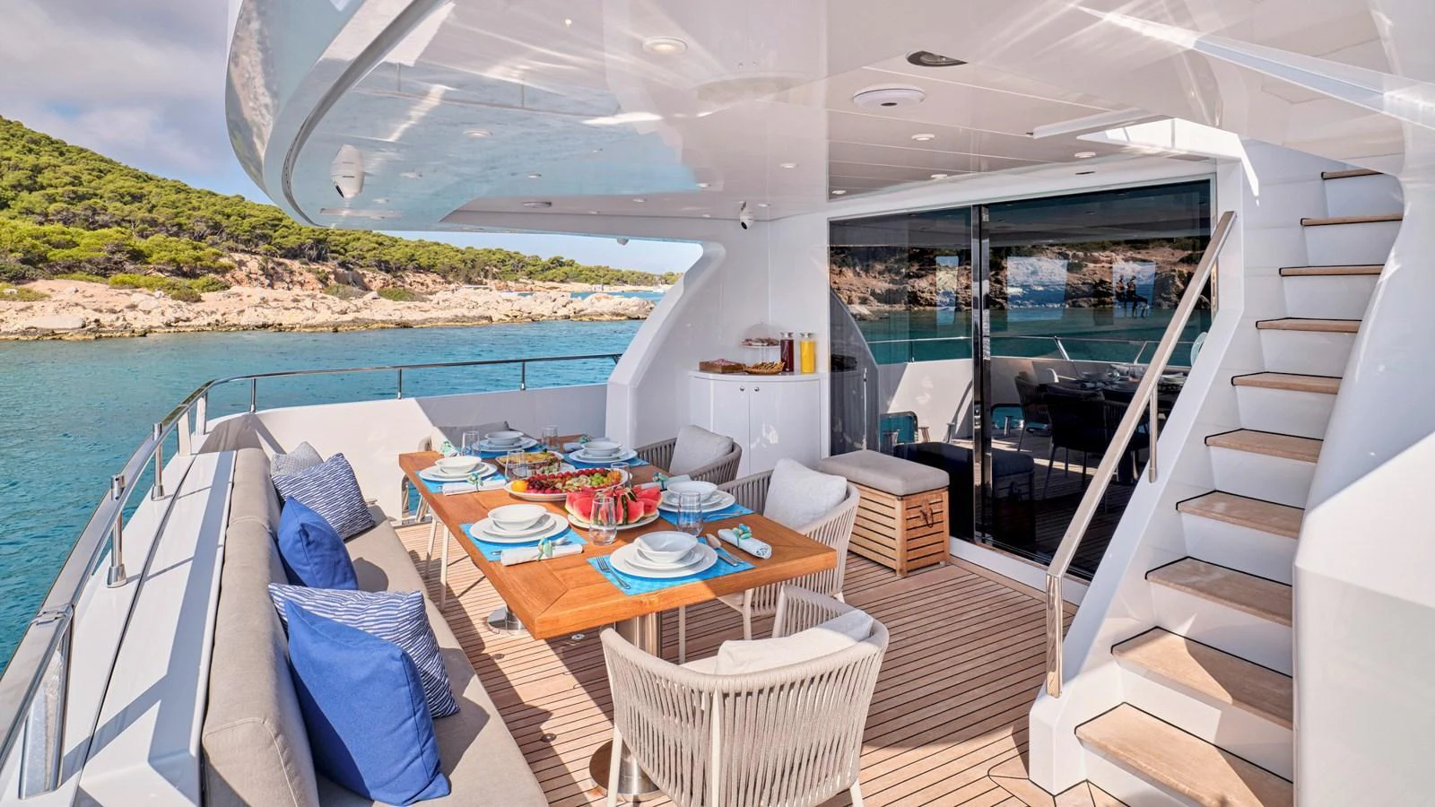 The aft deck features an elegant dining area with a stunning view of the surrounding waters. aboard MILGAUSS Yacht for Sale