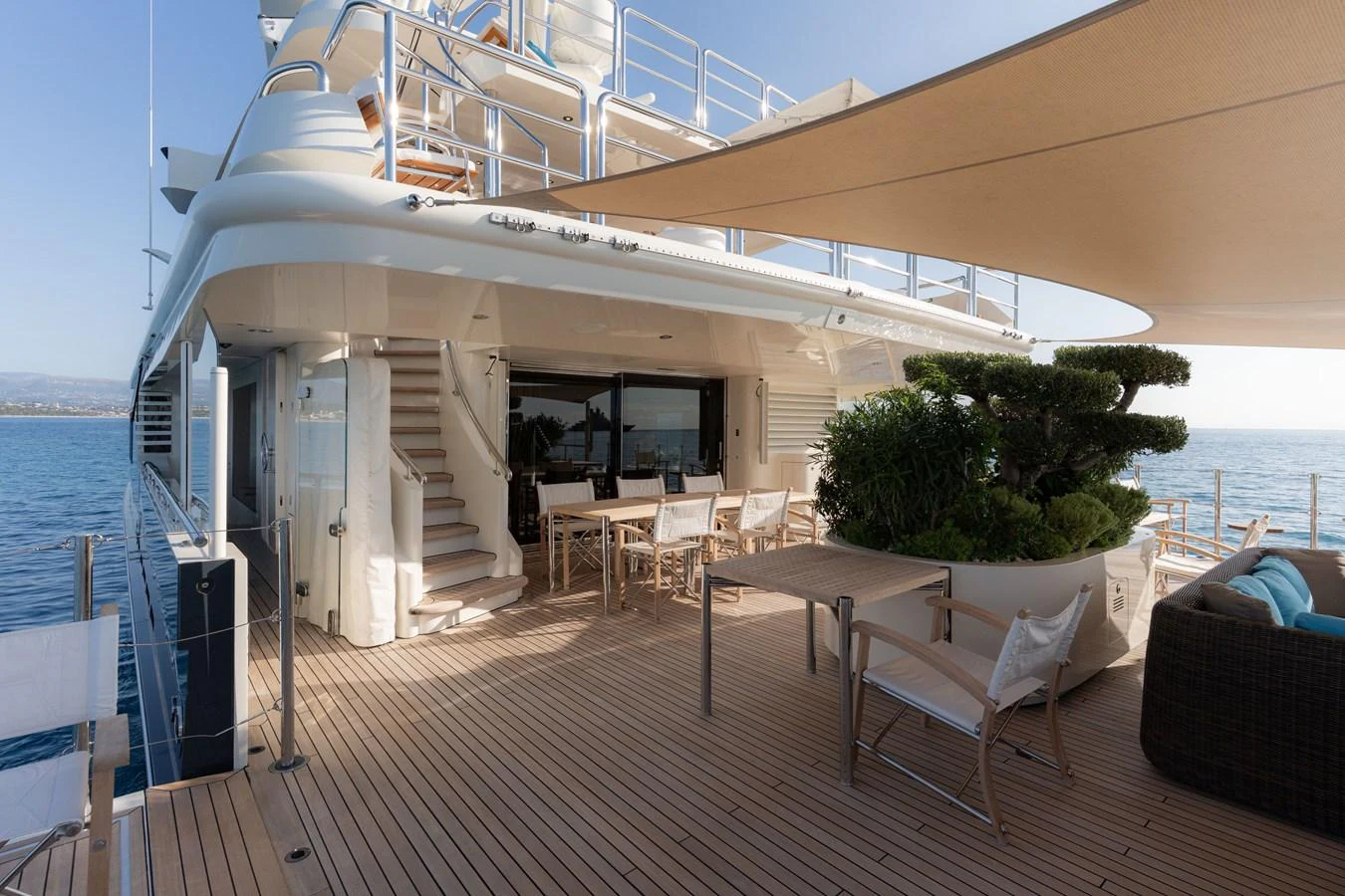 The yacht's aft deck offers a spacious and inviting area for relaxation and dining with stunning ocean views. aboard RENEGADE Yacht for Sale