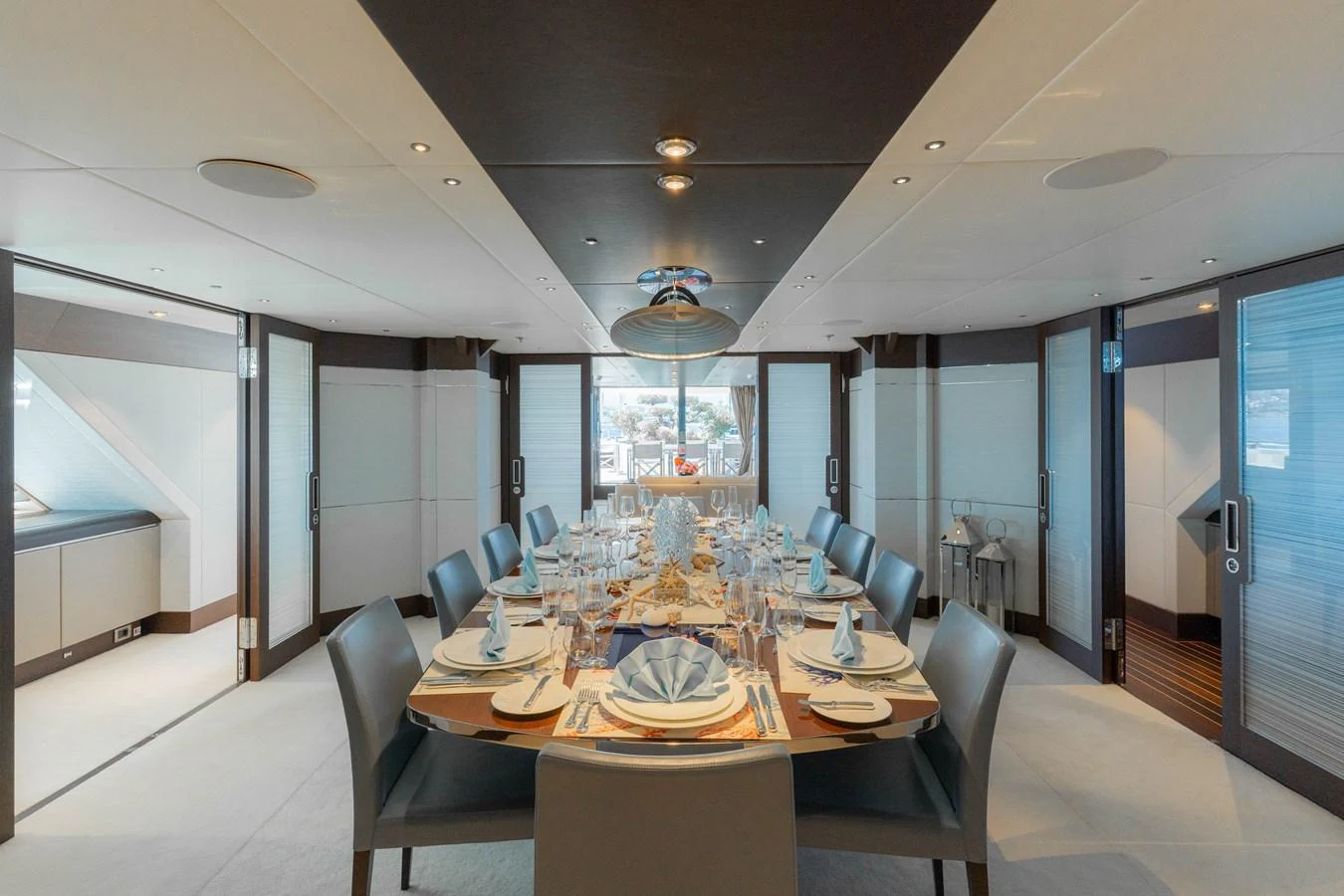 The elegant dining area features a beautifully set table with ample seating, perfect for sophisticated meals on board. aboard RENEGADE Yacht for Sale