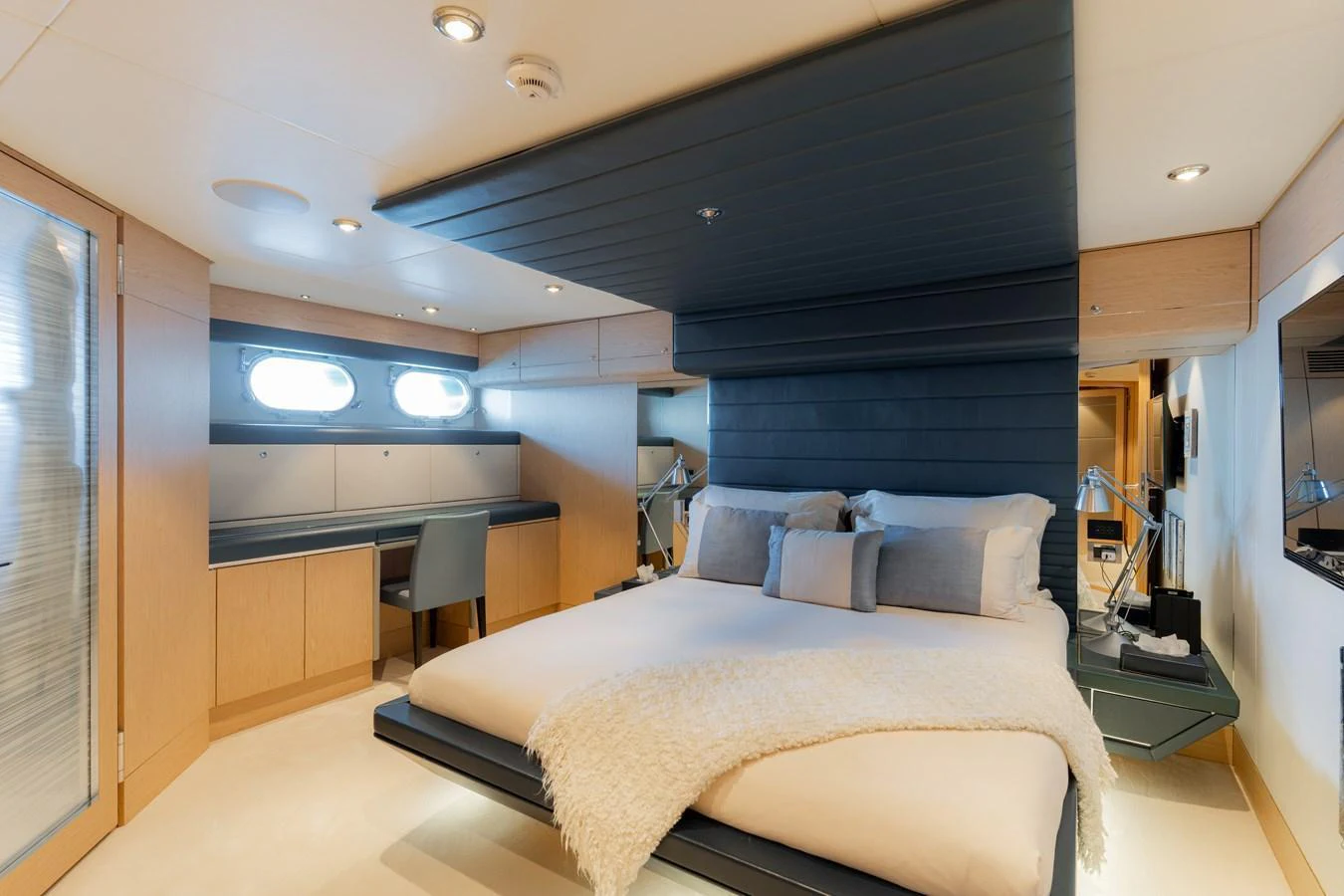 The master stateroom features a luxurious bed with modern decor and ample natural light. aboard RENEGADE Yacht for Sale