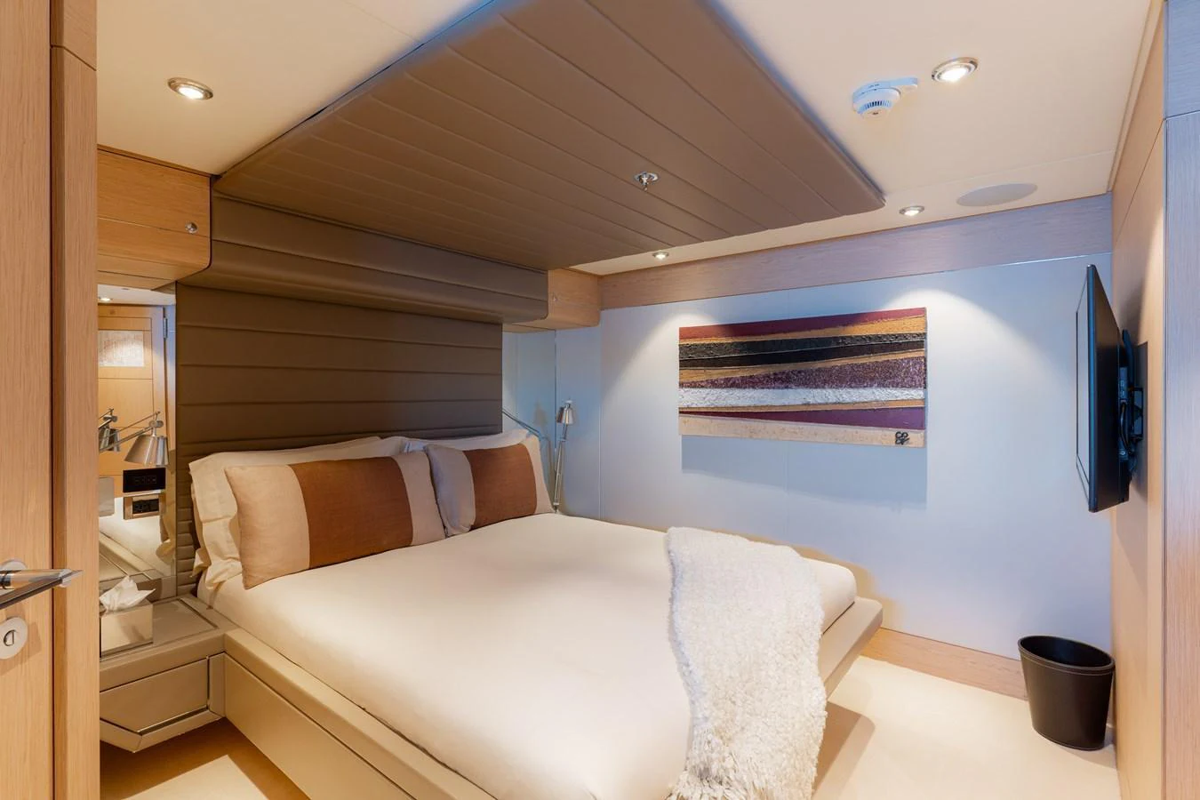 The stateroom features a cozy bed with modern decor and ambient lighting. aboard RENEGADE Yacht for Sale