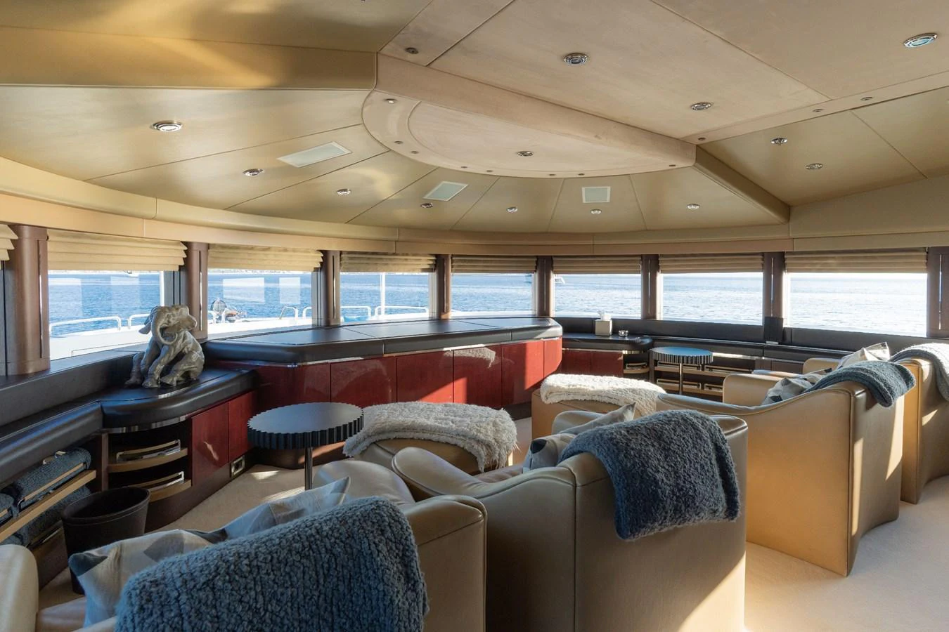 The yacht's salon features plush seating and panoramic windows offering stunning ocean views. aboard RENEGADE Yacht for Sale