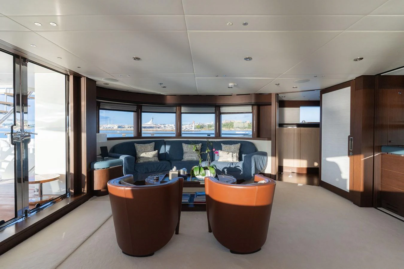 The salon offers a spacious and inviting area with ample seating and large windows providing panoramic views. aboard RENEGADE Yacht for Sale