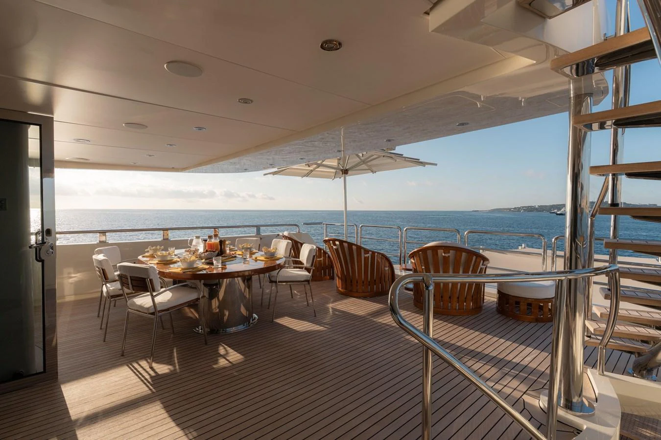 The aft deck offers a luxurious dining area with stunning ocean views. aboard RENEGADE Yacht for Sale