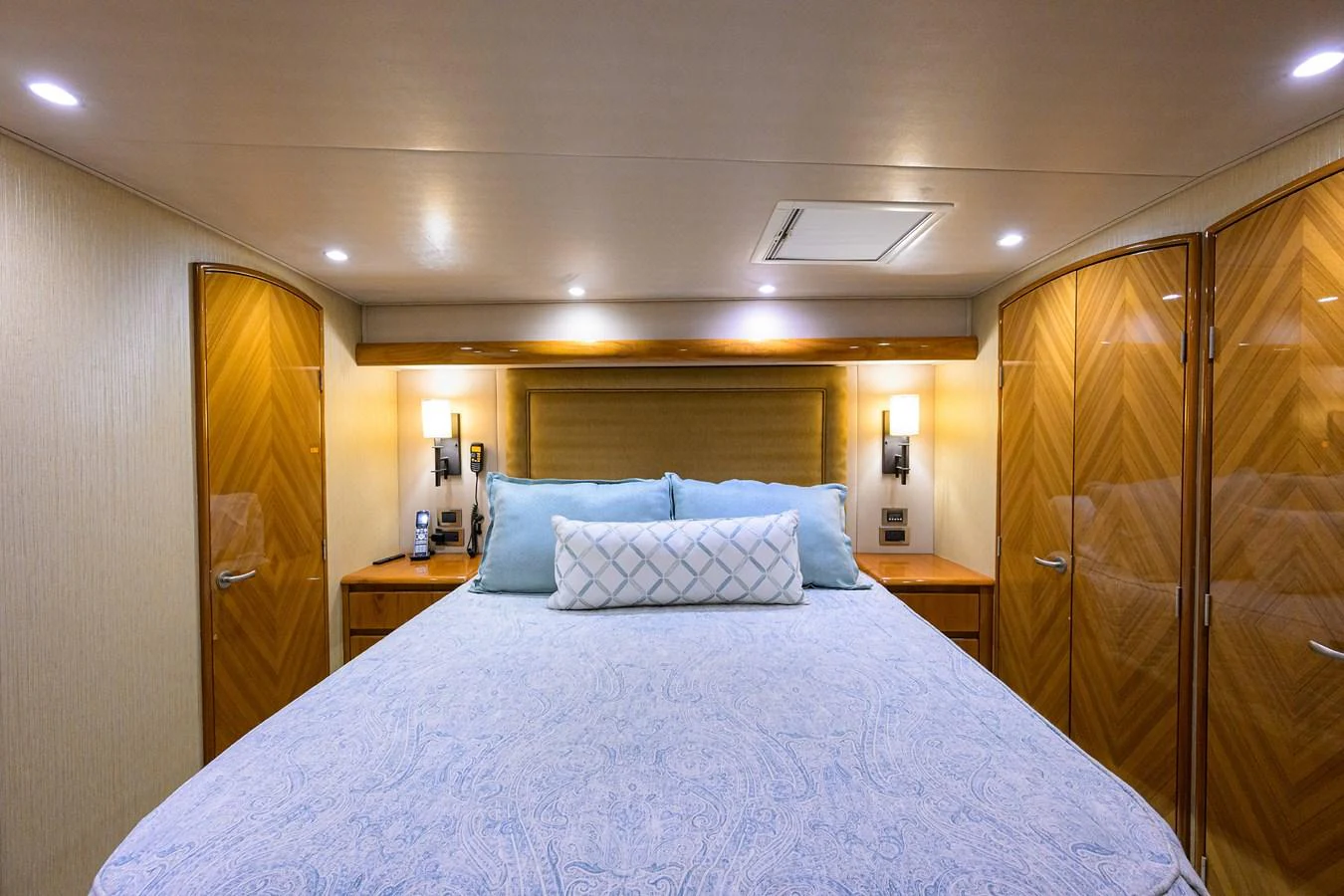 a bed with a blue comforter aboard MARLIN MONROE Yacht for Sale