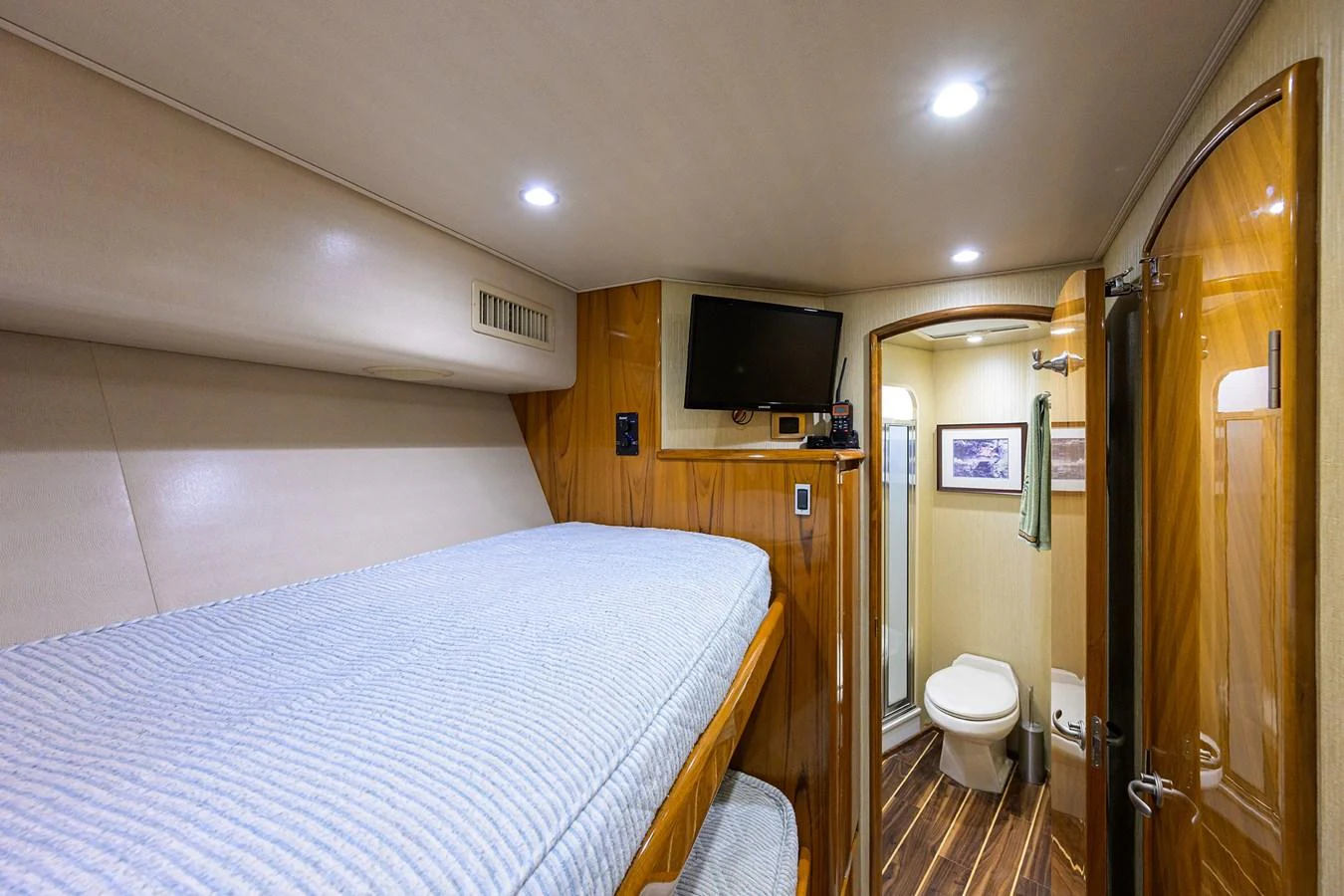 a bedroom with a bed and a television aboard MARLIN MONROE Yacht for Sale