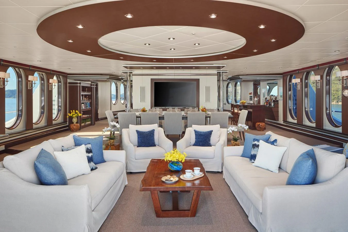 The yacht's salon features plush seating, elegant decor, and expansive windows for a luxurious and comfortable atmosphere. aboard GLOBAL Yacht for Sale