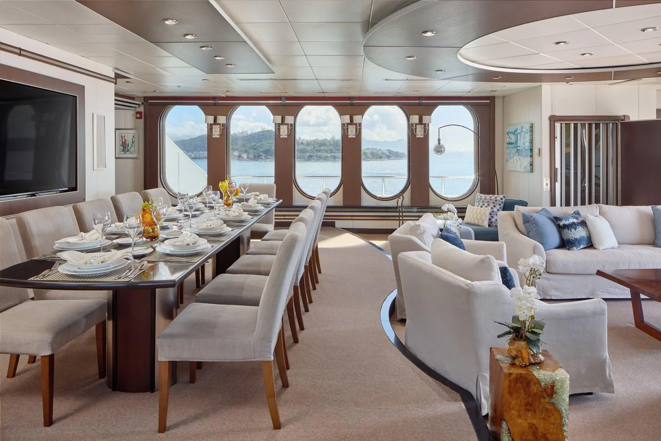 The salon features elegant dining and comfortable seating with large windows offering stunning views. aboard GLOBAL Yacht for Sale