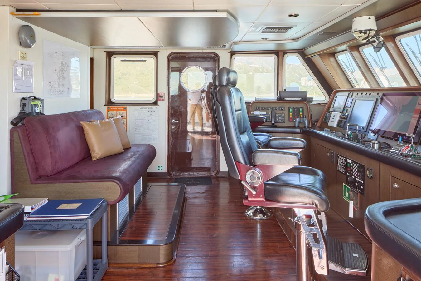 The helm station features a sophisticated control area with plush seating and advanced navigation equipment. aboard GLOBAL Yacht for Sale
