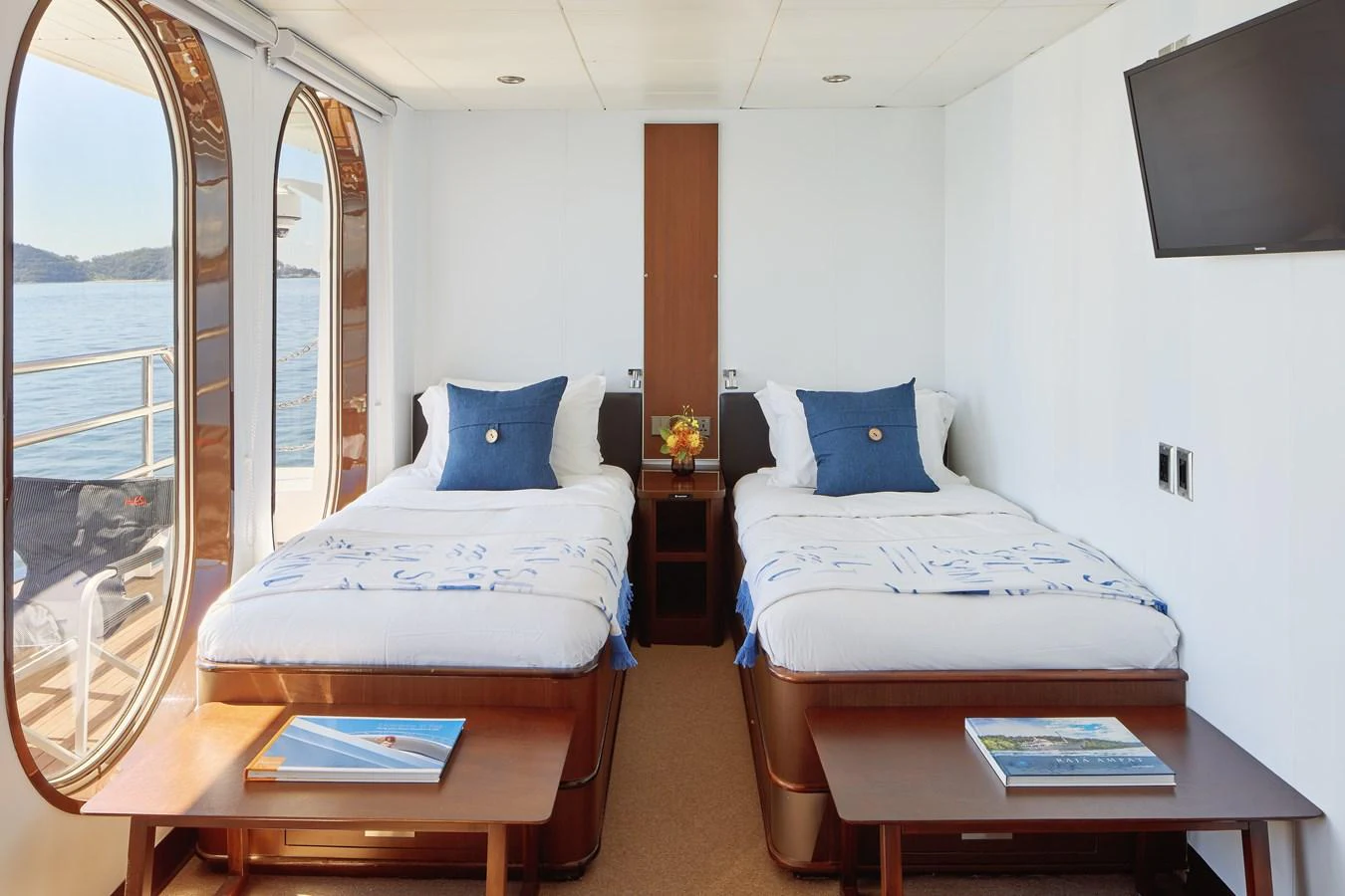 A bright and inviting twin stateroom with large windows offering scenic views. aboard GLOBAL Yacht for Sale