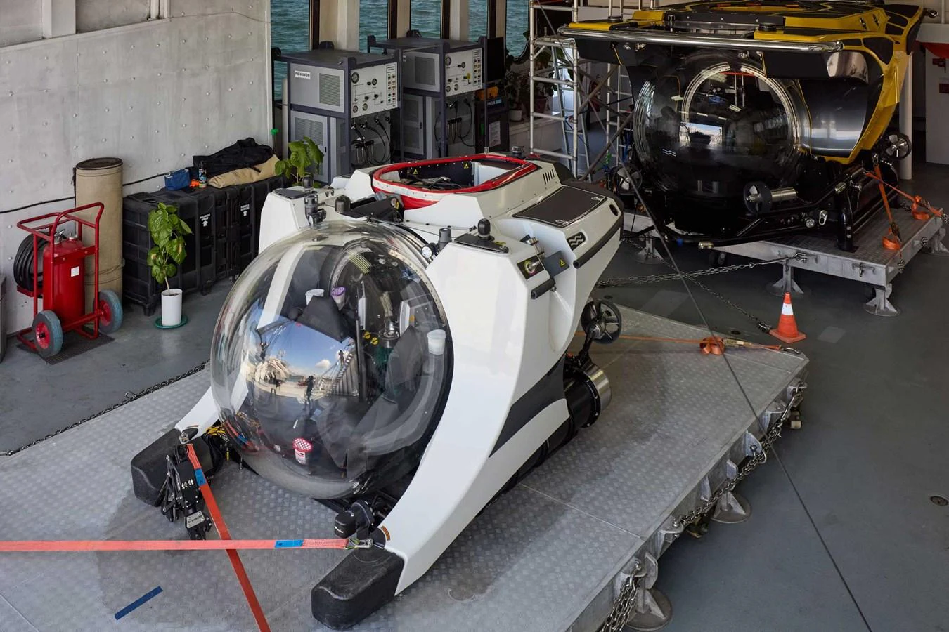 The image showcases advanced submersibles stored in the yacht's garage, ready for underwater exploration. aboard GLOBAL Yacht for Sale