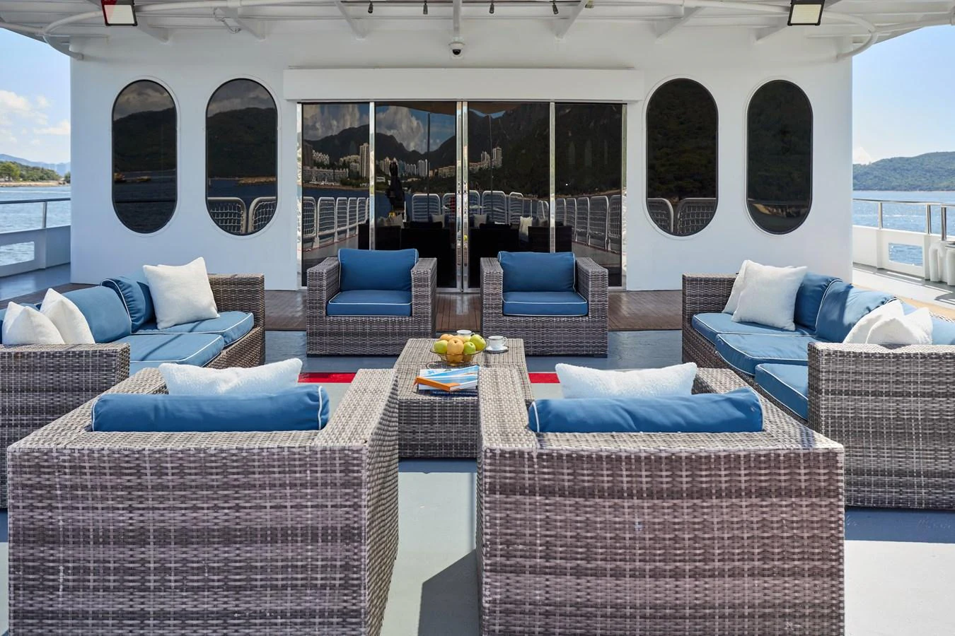 The aft deck features a stylish outdoor lounge area with comfortable wicker seating and plush cushions. aboard GLOBAL Yacht for Sale