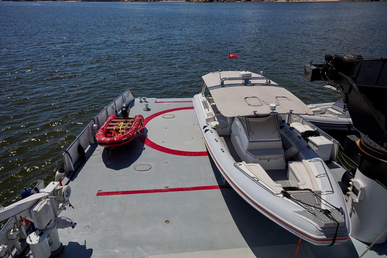 The yacht features a spacious deck area with a tender and a small inflatable boat, perfect for exploring the surrounding waters. aboard GLOBAL Yacht for Sale