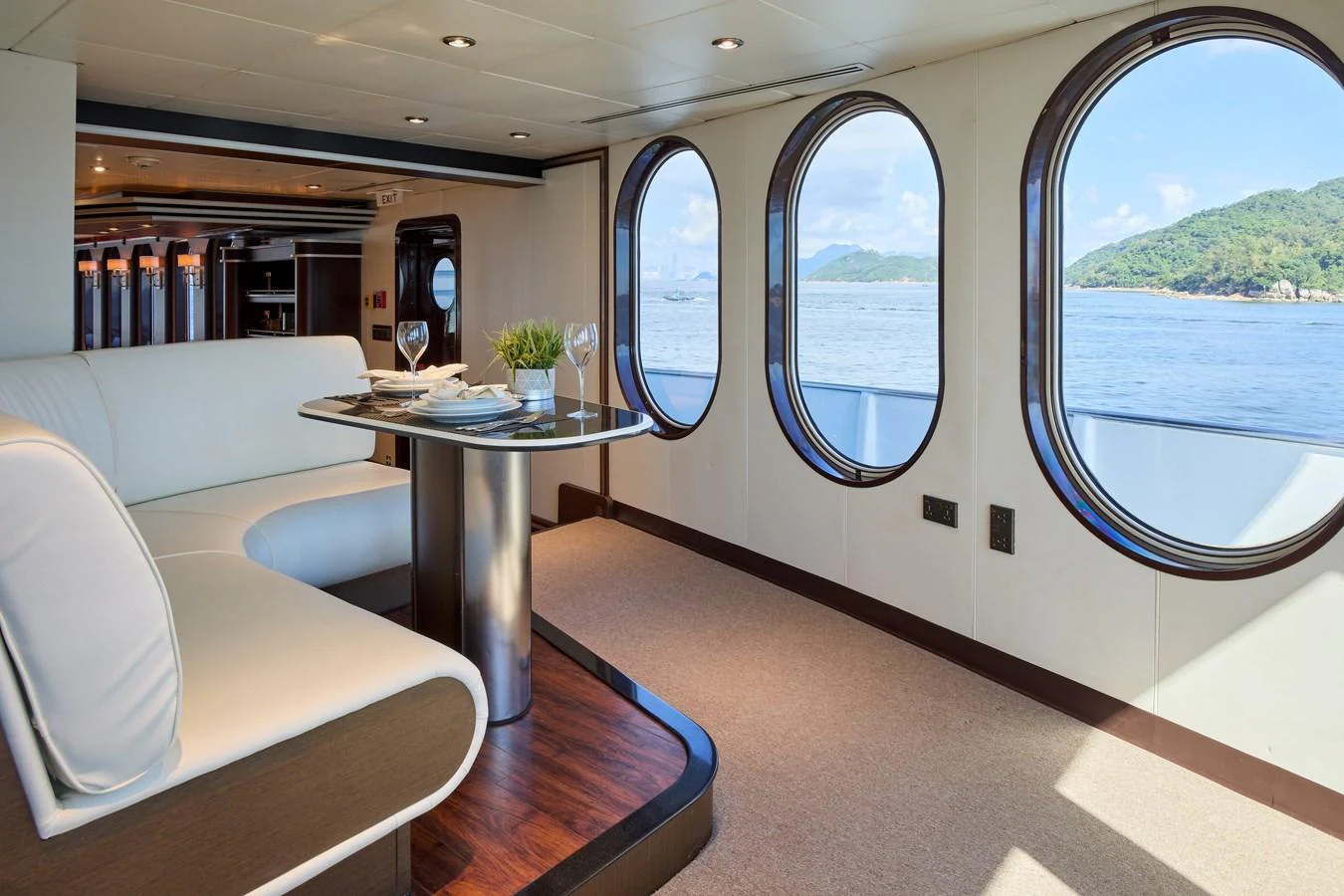 The yacht's dining area features elegant furnishings and large windows offering stunning sea views. aboard GLOBAL Yacht for Sale