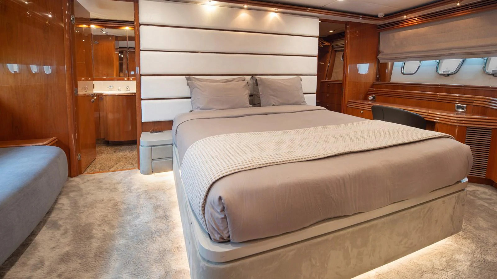 The master stateroom features a luxurious bed with plush bedding and elegant wood paneling. aboard MI ALMA Yacht for Sale