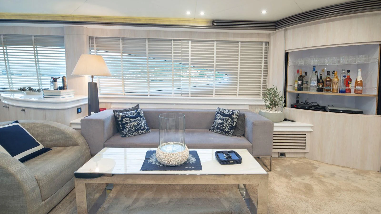 The yacht's salon features a comfortable seating area with a well-stocked bar and elegant decor. aboard MI ALMA Yacht for Sale
