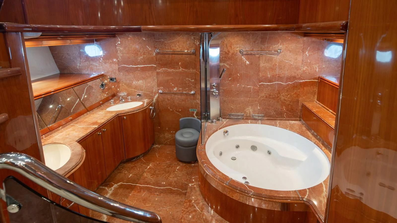 The yacht's bathroom features luxurious marble finishes and a spacious jacuzzi tub. aboard MI ALMA Yacht for Sale