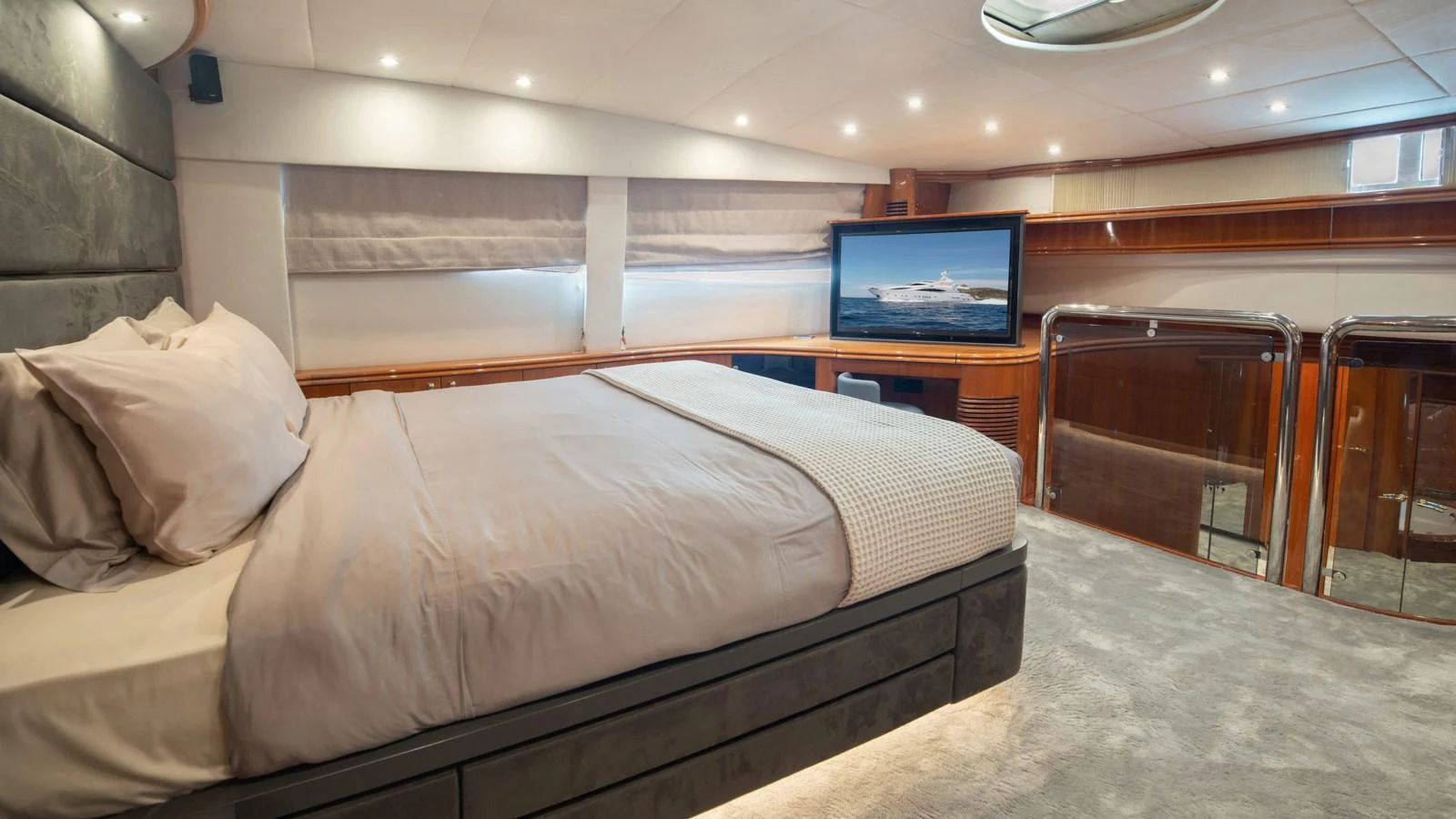 The master stateroom features a luxurious bed, modern decor, and a large TV for ultimate relaxation. aboard MI ALMA Yacht for Sale
