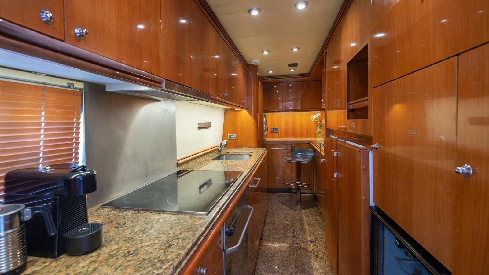 The galley features warm wood cabinetry and modern appliances, creating a functional and inviting space. aboard MI ALMA Yacht for Sale