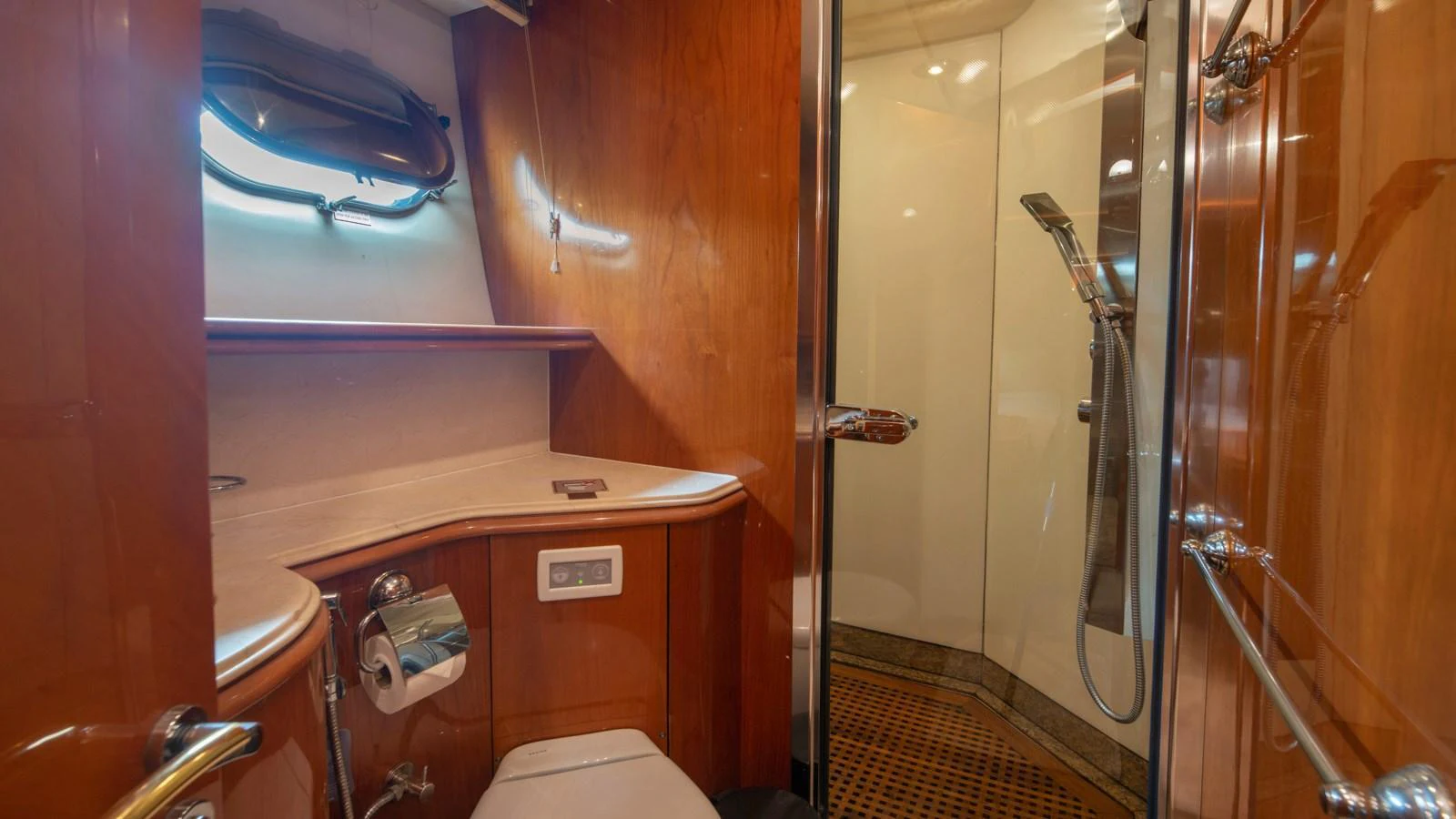 The yacht's bathroom features a sleek design with wooden cabinetry and a modern shower. aboard MI ALMA Yacht for Sale