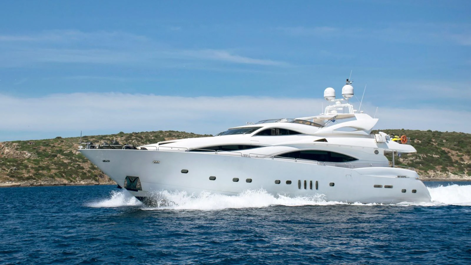 A sleek and modern yacht cruising through the water with a scenic backdrop. aboard MI ALMA Yacht for Sale