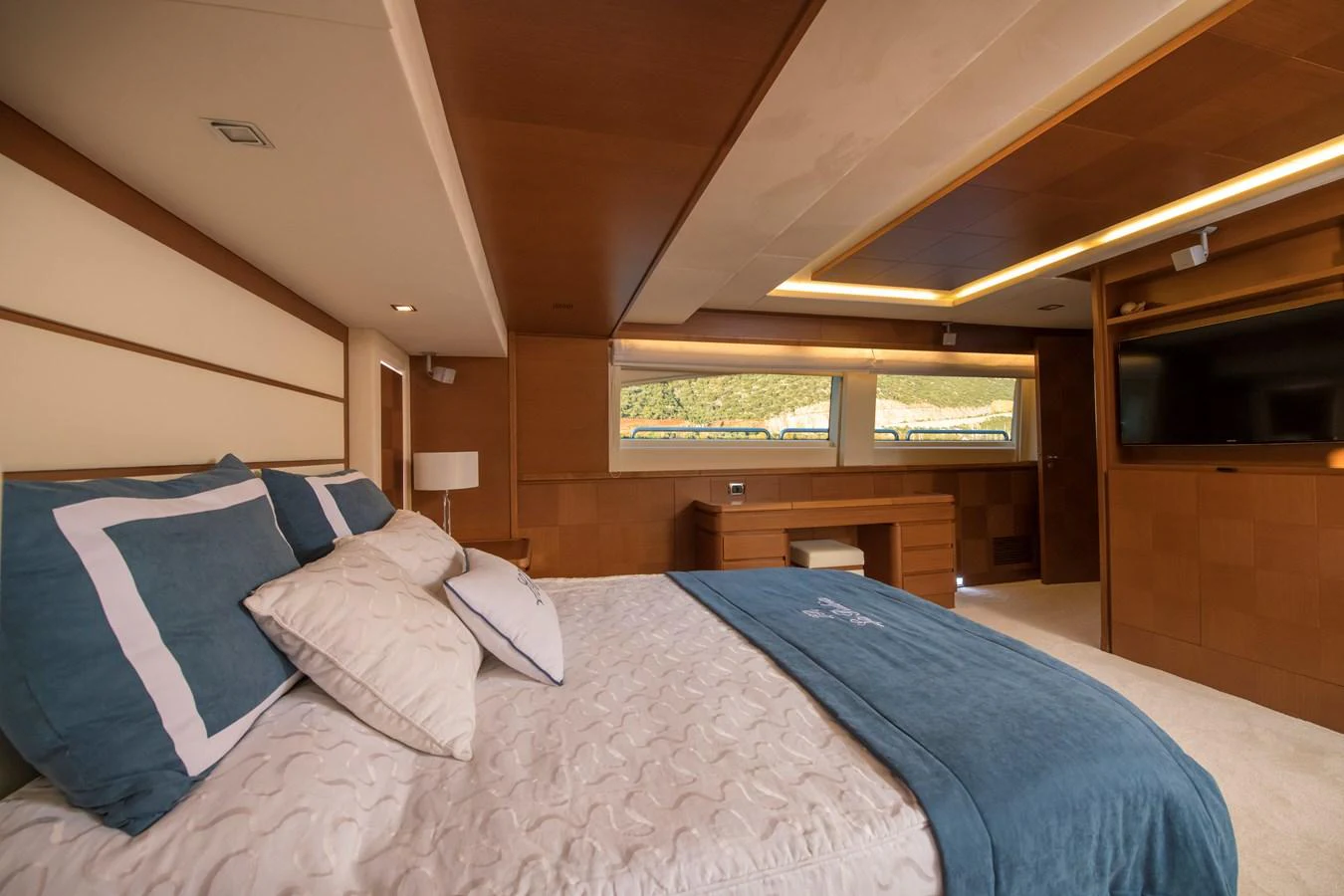 a bed with blue sheets aboard LA RUBIA Yacht for Sale