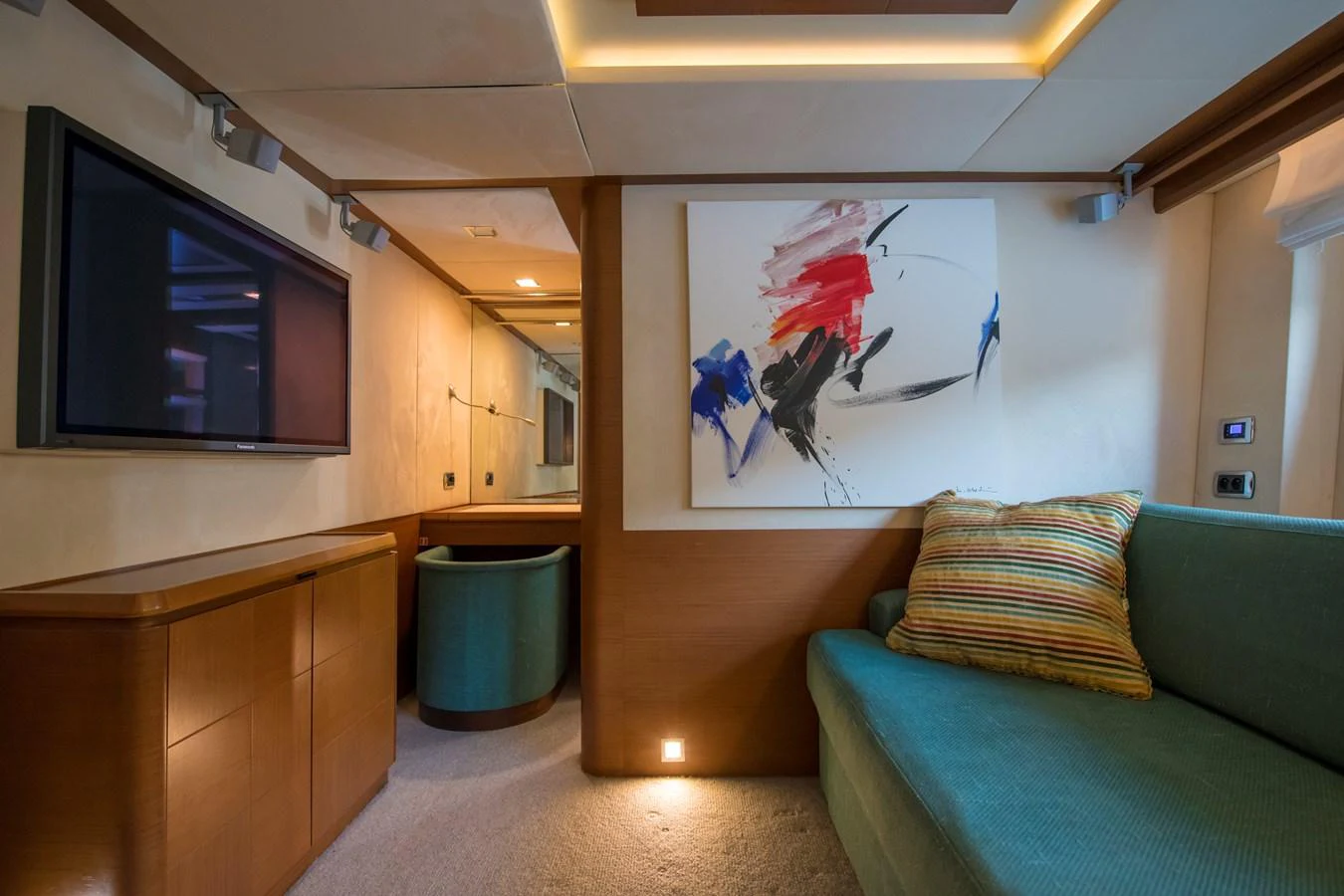 a living room with a couch and a television aboard LA RUBIA Yacht for Sale