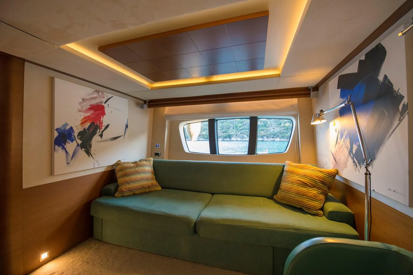 a living room with a couch and a television aboard LA RUBIA Yacht for Sale