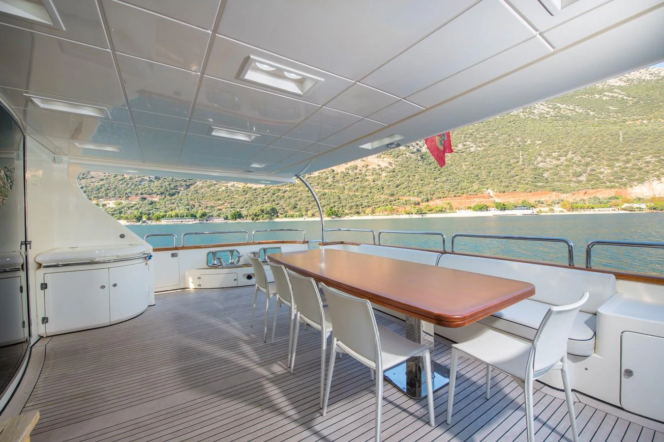a table and chairs on a deck aboard LA RUBIA Yacht for Sale