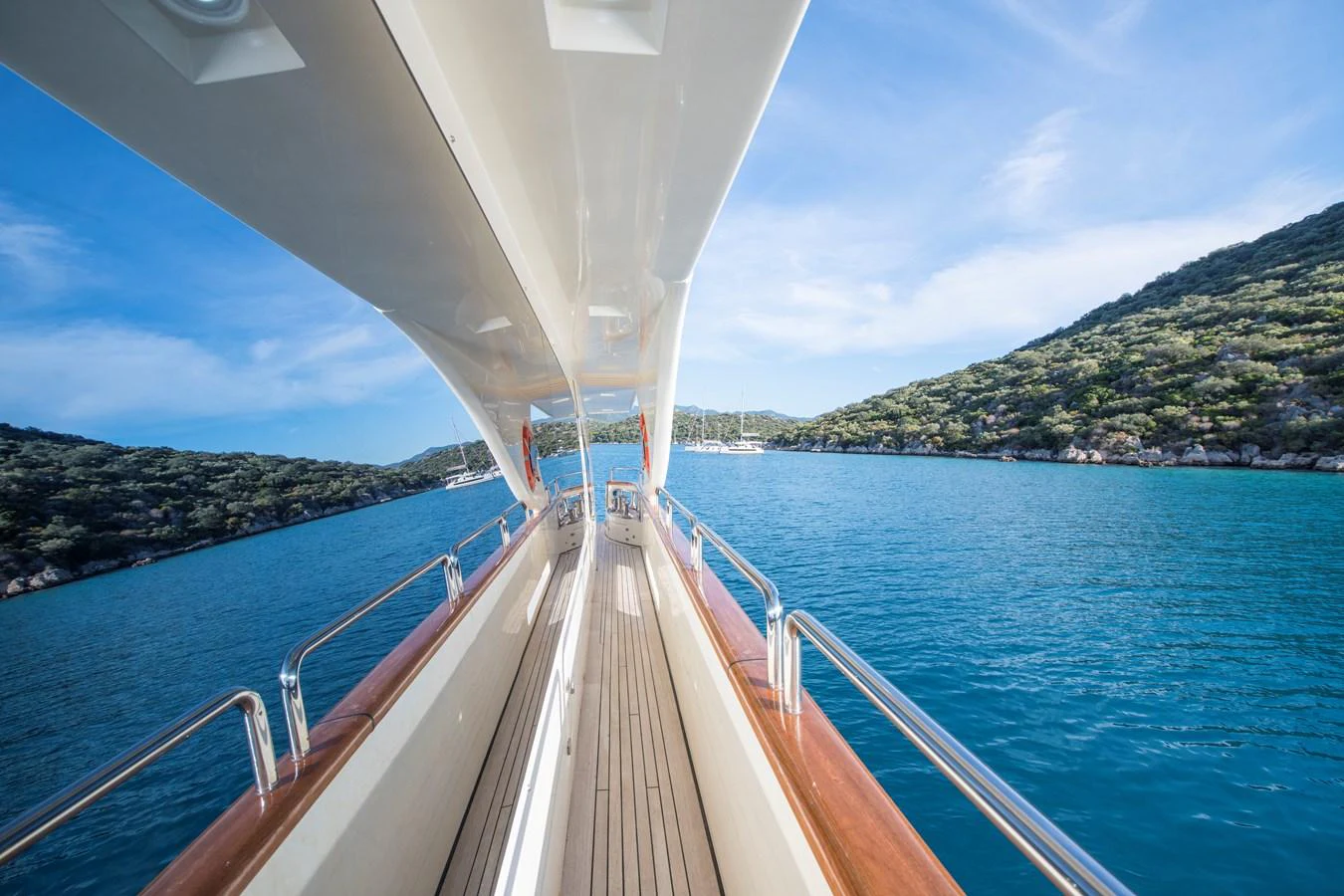 a boat on the water with Sundial Bridge at Turtle Bay in the background aboard LA RUBIA Yacht for Sale