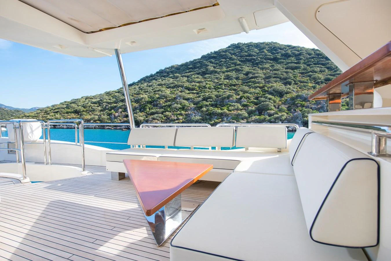 a deck with a view of a mountain aboard LA RUBIA Yacht for Sale