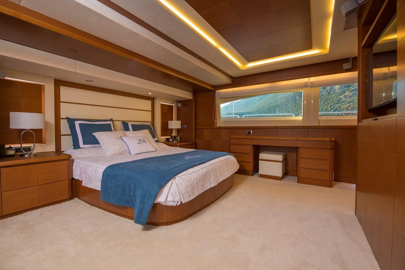 a bedroom with a bed and a desk aboard LA RUBIA Yacht for Sale