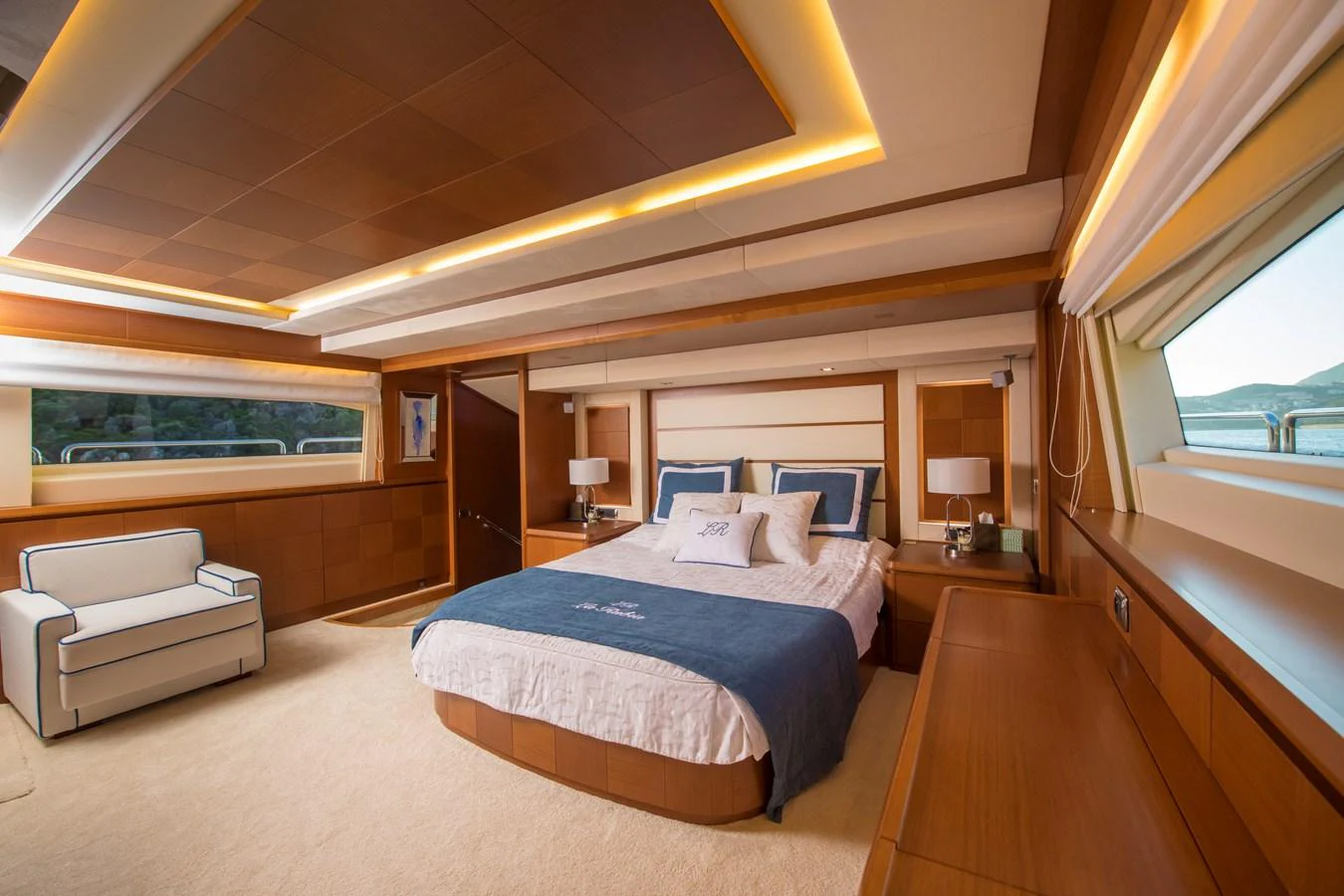 a bedroom with a bed and a desk aboard LA RUBIA Yacht for Sale