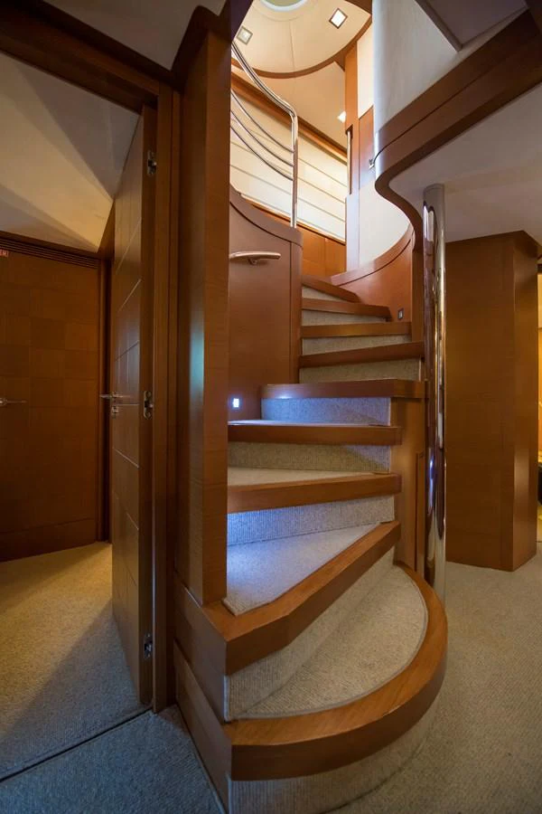 a staircase with wood walls aboard LA RUBIA Yacht for Sale
