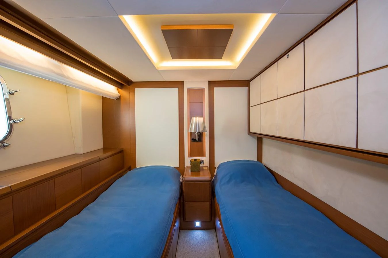 a room with a bed and a lamp aboard LA RUBIA Yacht for Sale