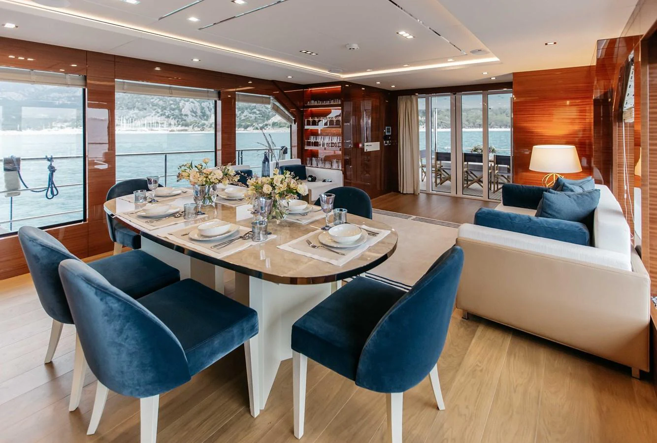 a room with a table and chairs aboard PAPILLON Yacht for Sale
