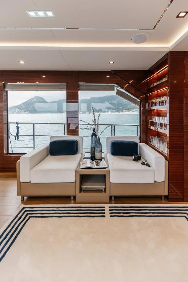 a living room with a large window aboard PAPILLON Yacht for Sale